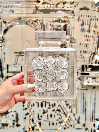 Everlasting Roses in Parfum Box - White with a backdrop of black and white artwork.
