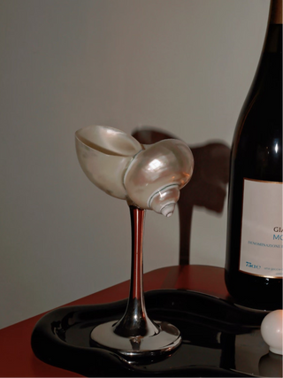 Seashell Enchanté Cup™️ Set of 2 next to an old bottle of Italian red wine.