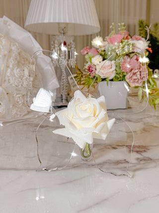 A close up of the Château Butterfly Acrylic Vase with white florals.