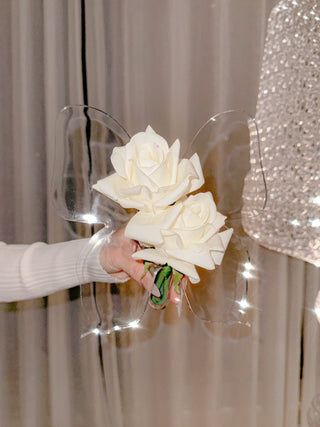 The Château Butterfly Acrylic Vase with a silky curtain backdrop.