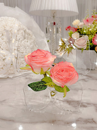 Château Butterfly Acrylic Vase with flowers, atop a marble dining table.
