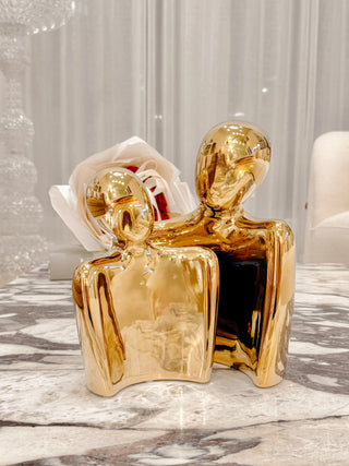 'Forever Us' Romantic Couple Statue - XXL Gold Electroplated atop a marble coffee table.