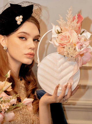 A beautiful model posing with the Sofia Round Handbag Resin Vase.