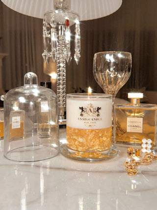 The Majesté Dorée Gold Leaf Candle With Bell Cloche displayed luxuriously.