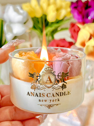 A lit Peony Bouquet Candle.