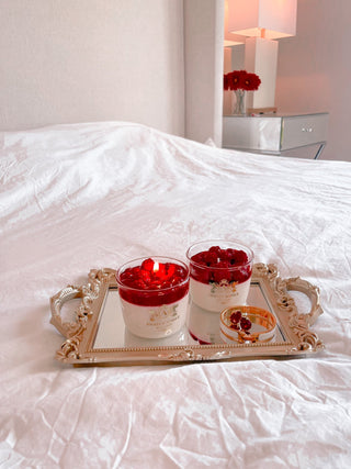 Raspberry Mousse Candle atop a golden framed mirror tray.
