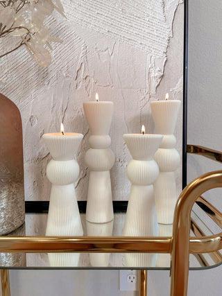 Enzo XXL Pillar Candle Set of 2 atop a gold bar cart.
