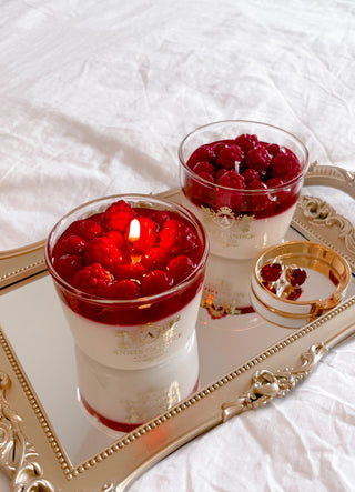 Raspberry Mousse Candle with a lit flame.