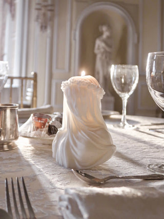 An 'Amour, Anaïs' candle atop a wedding banquet table.