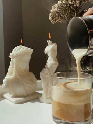 Pouring a french latte next to a an 'Amour, Anaïs' and Venus candle.