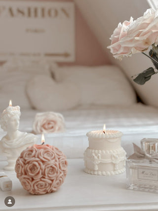 The Flower Romance in French Rose Pink, next to the Noah Candle.