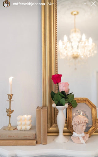 “I Heart You” Candle atop a marble mantle.