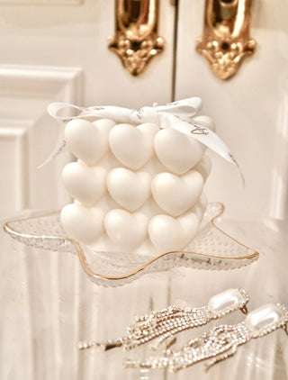 A close up of the “I Heart You” Candle in a classy hotel setting.