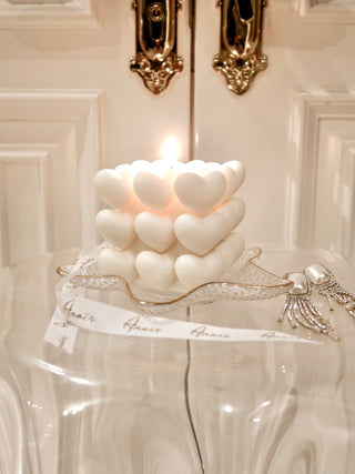 A lit “I Heart You” Candle in a classy hotel setting.