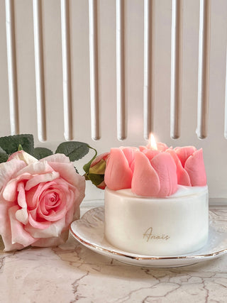 Amelie Tulips Bouquet Candle lit, next to a pink flower.