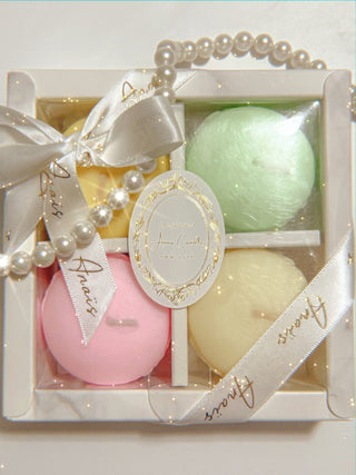 The French Macaron Candle Set of Four - Holiday Edition, in its gift packaging.