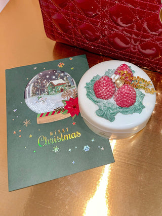 Shake-To-Snow Holiday Card next to an Anaïs Christmas themed cake candle.