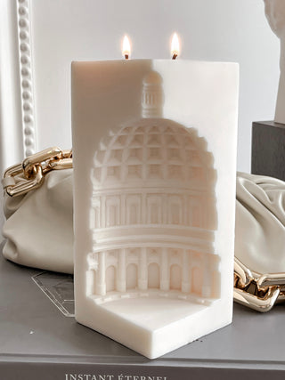 A close up of a lit ‘When in Rome’ 2-Wick Candle.