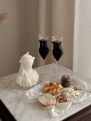 The Lady Glass Cup Set - Handblown next to a charcuterie board.