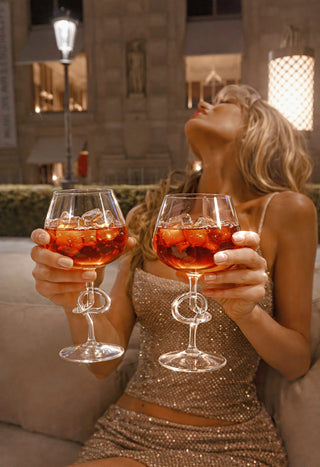 Two people toasting with The Versailles Knot Glasses Set of 2.