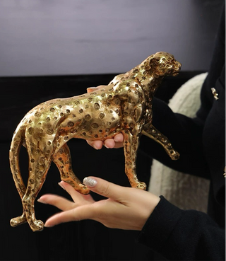 Prestigious Golden Leopard being held by a model.