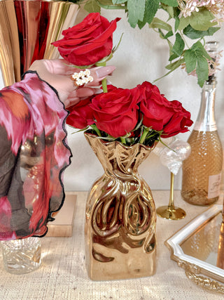 Giovanna Golden Bag Vase with an extravagant bouquet.