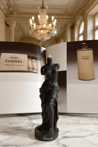 The Venus Candle in Ultra Black in a palace-like hotel.