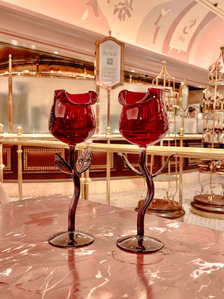 Rose for Rose Glass Cup Set of 2 with a backdrop of a luxurious gold adorned restaurant with high ceilings.