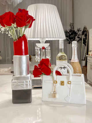 Luxurious Lipstick Resin Vase - XXL next to a Victoria Resin Handbag Vase with blooming red roses.