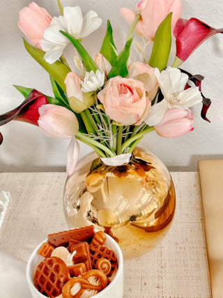 Modern Lux Golden Ball Vase with a variety of flowers.