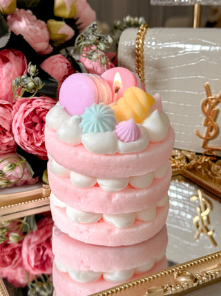 Dreamy Macarons & Cream Tart Candle with floral bouquet in background.
