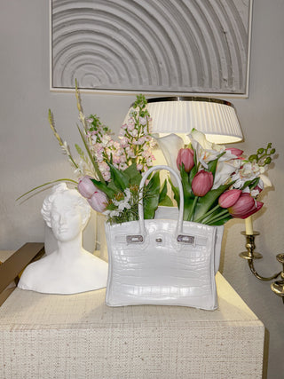 Sandra Handbag Resin Vase atop a luxurious, modern credenza.