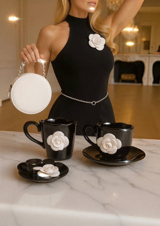 The Camellia Romance Ceramic Tea/Coffee Cup Set of 2 atop a Carrara marble table.
