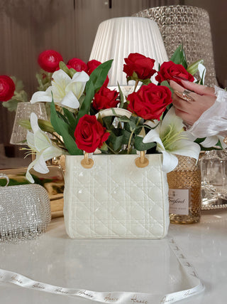 Scarlett Handbag Resin Vase in Beige with blooming red and white flowers.