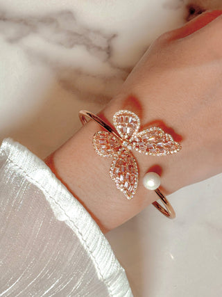 Dreamy Butterfly Bangle Bracelet on model atop a marble table.