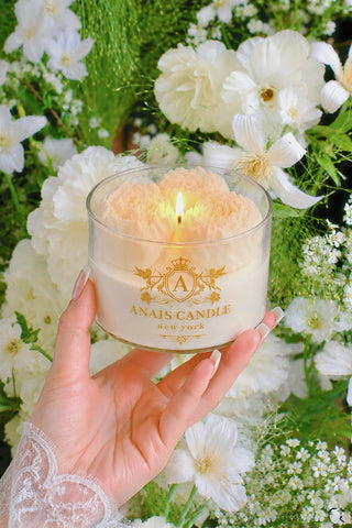 Peony Bouquet Candle in White placed on a marble bedside table