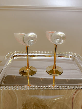 Seashell Enchanté Cup™️ Set of 2 atop a silver platter.