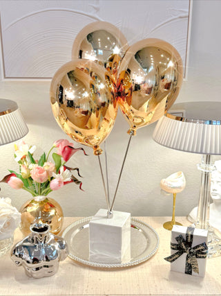 Golden Balloons Sculpture Decor atop a modern credenza.