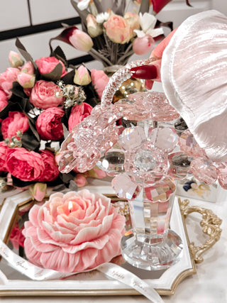 Crystal Glass Blooming Flowers Basket surrounded by blooming florals.