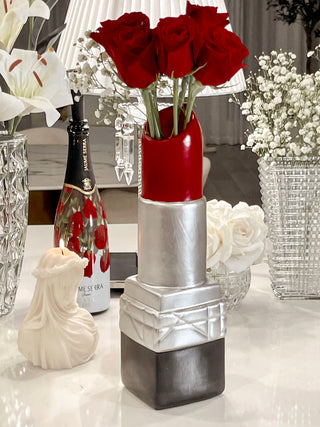 Luxurious Lipstick Resin Vase - XXL next to an Amour, Anais candle.