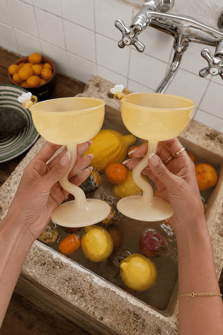 Summer Bee Glass Cup Set Of 2 on a glass table in a Miami penthouse