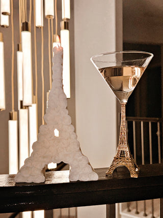 Rosy Eiffel Tower Candle in White atop a banister.