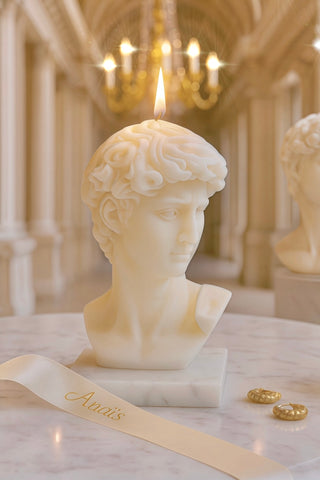 A lit Anais Man Candle in Sculpture White.