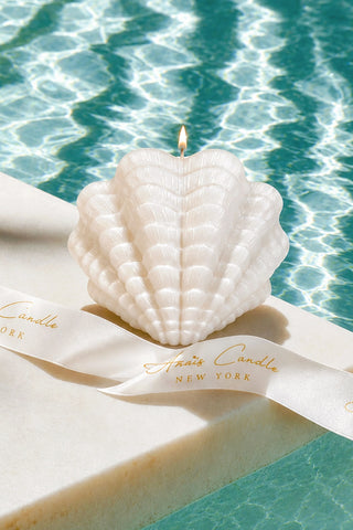 Sirène Shell Candle - XXL on a polished stone side table in a private lounge