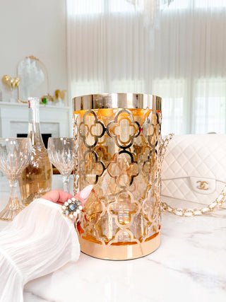 A woman holding a Timeless Metal Four-Leafed Clover Glass Vase.