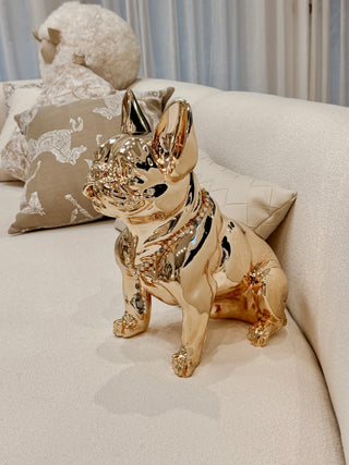 Golden French Bulldog Statue relaxing on a couch.