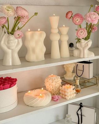“Her” & Angelica Ceramic Vase Set of 2 on a shelf next to other signature candles by Anaïs Candle.
