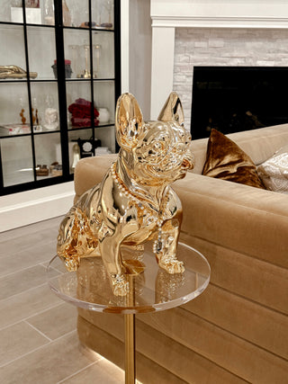 Golden French Bulldog Statue sitting on an acrylic side table.