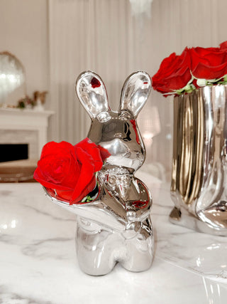 Mr. Bunny Vase - Sliver surrounded by red rose bouquets.