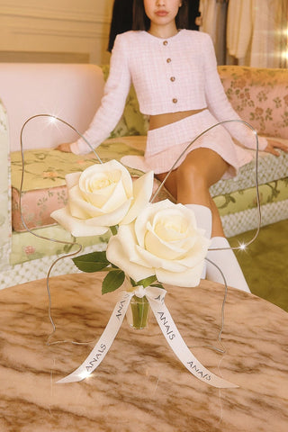 Château Butterfly Acrylic Vase decorated with white florals in a 5-star hotel.